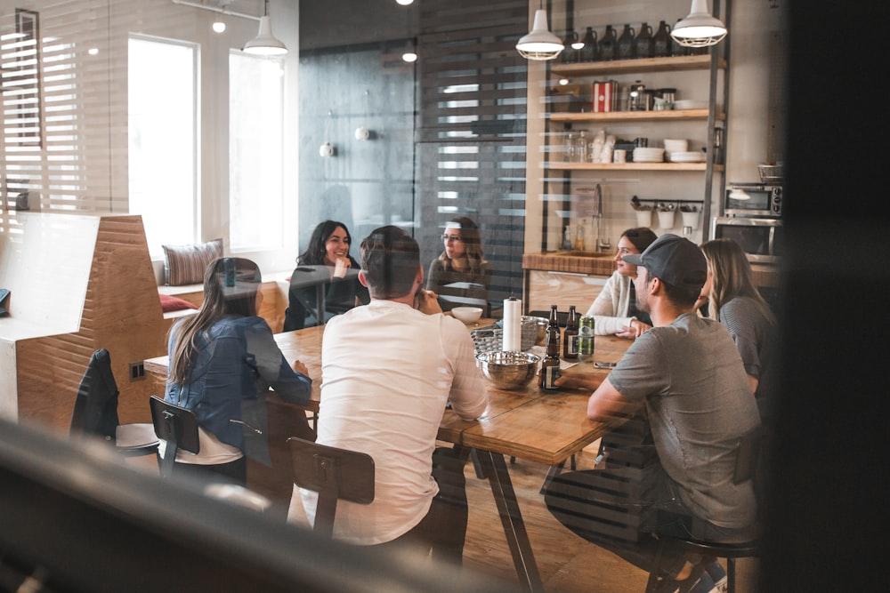 An agency team working together over laptops at a long table
