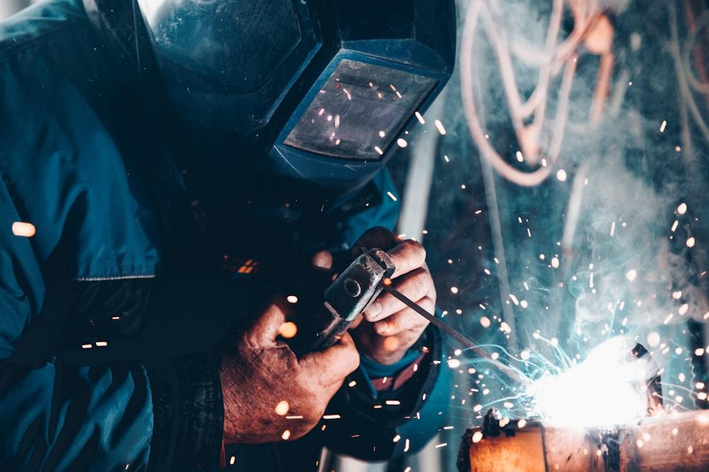 A welder working with sparks on a factory floor
