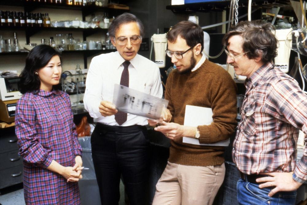A group reviewing technical drawings in an industrial setting
