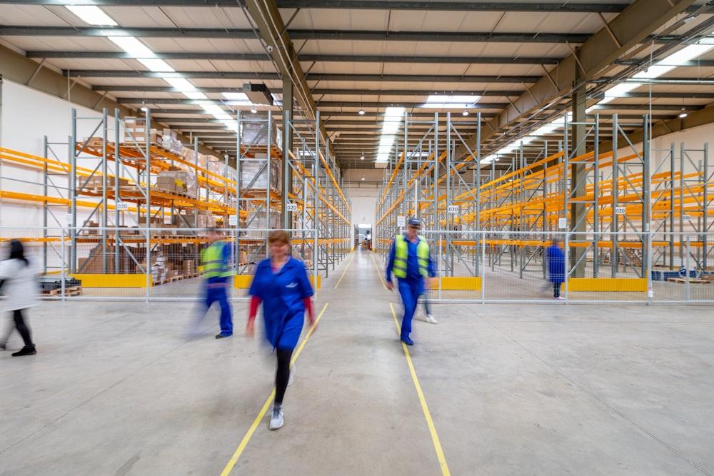 Workers moving through a warehouse aisle